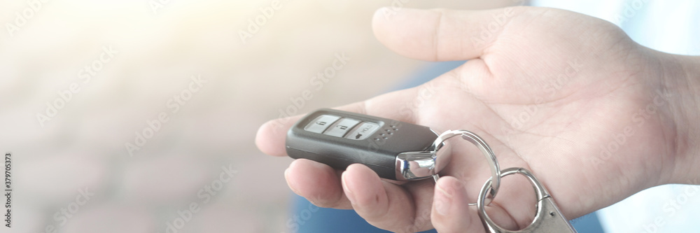 Fototapeta premium Car remote key in hand. Selective focus