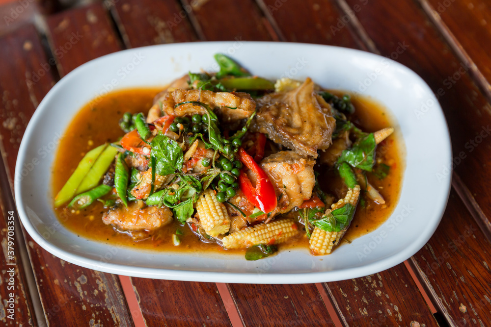 Spicy stir-fried fish with pepper, chili . Stir fried fish with Thai herbs, spicy local food, the unique spice of Thai food. image for objects copy space and menu list. fire Catfish Spicy Spicy stir-fried fish with pepper, chili . Stir fried fish with Thai herbs, spicy local food, the unique spice of Thai food. image for objects copy space and menu list. fire Catfish Spicy
