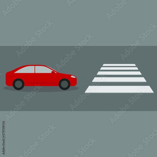 A car is sitting in front of a pedestrian crossing