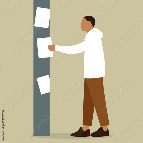 Male character glues a sheet of paper on a pillar