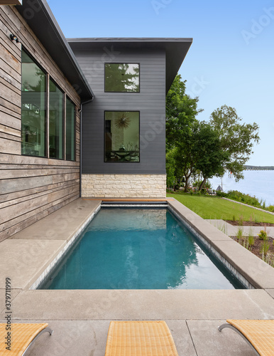 Outdoor swimming pool and  new modern luxury home exterior  © bmak