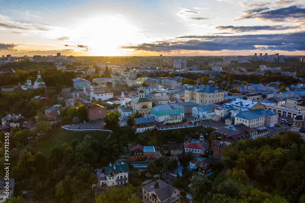 panoramic view of the old city district with old buildings and a church filmed from a drone