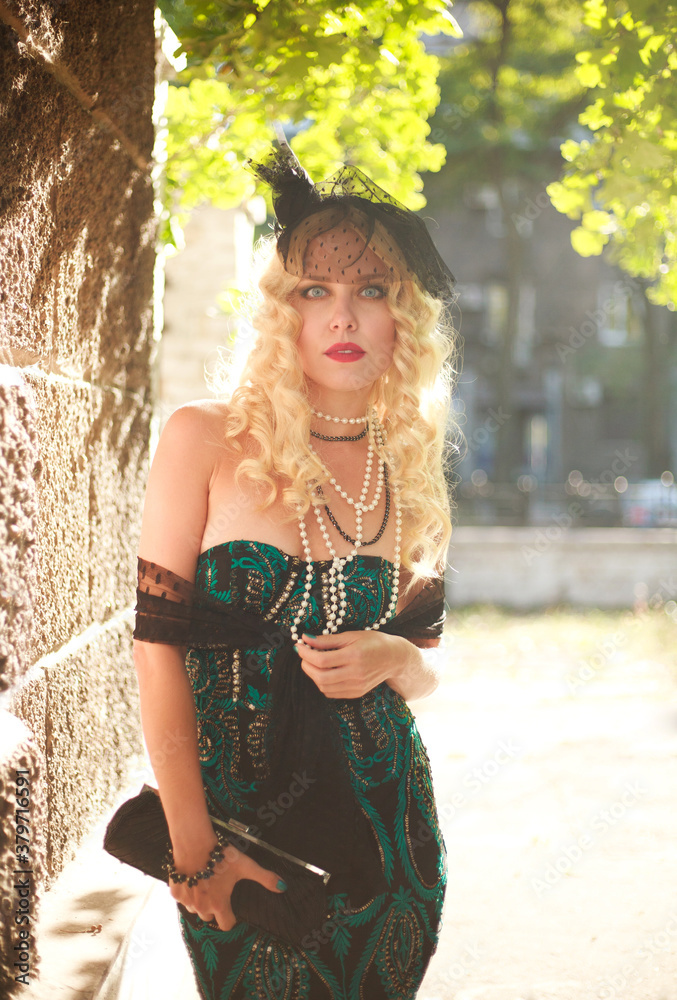 Fototapeta premium Elegant young lady in fashionable dress retro style, natural beauty portrait outdoors in sunlight