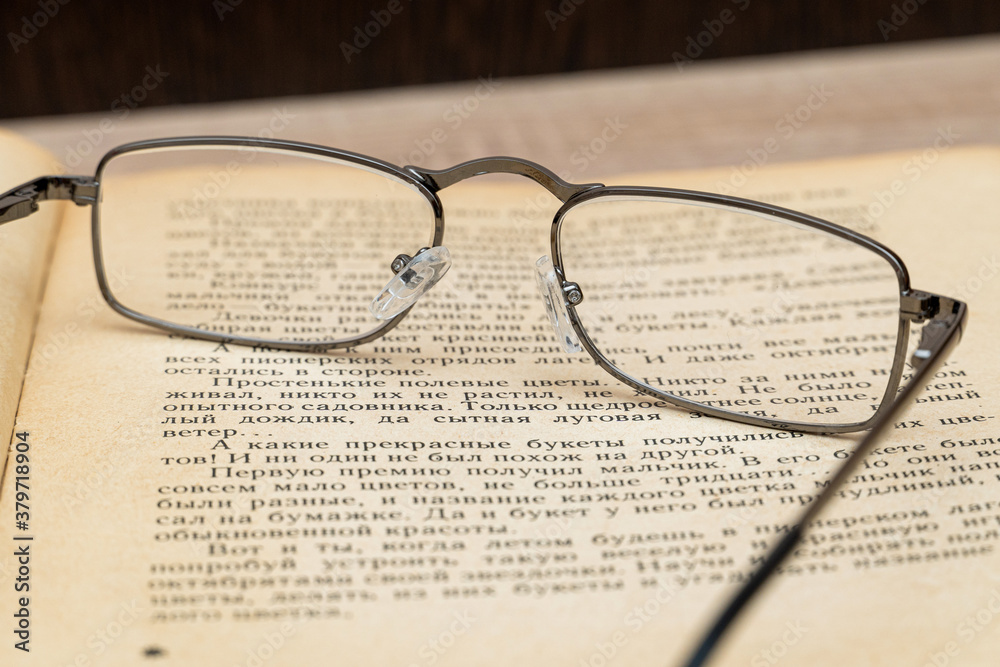 Glasses for reading on the book close up Glasses for reading on the book close up