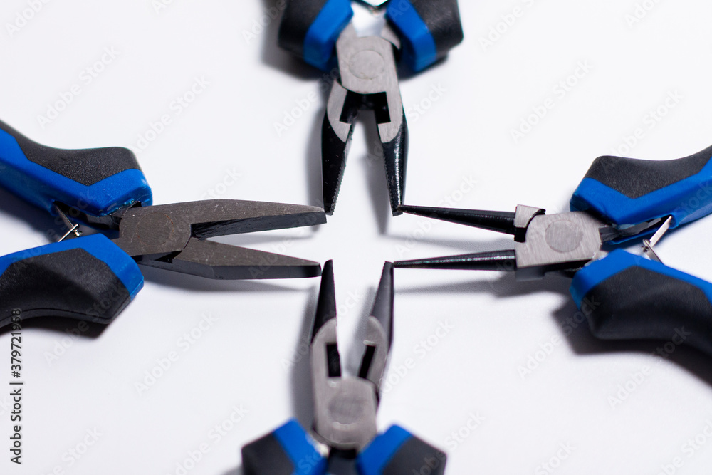 Geometric shape between clamping surfaces. Pliers on a white background.