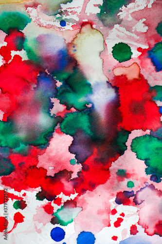 Ink drops on the paper, red, green and blue ink splashes background photo