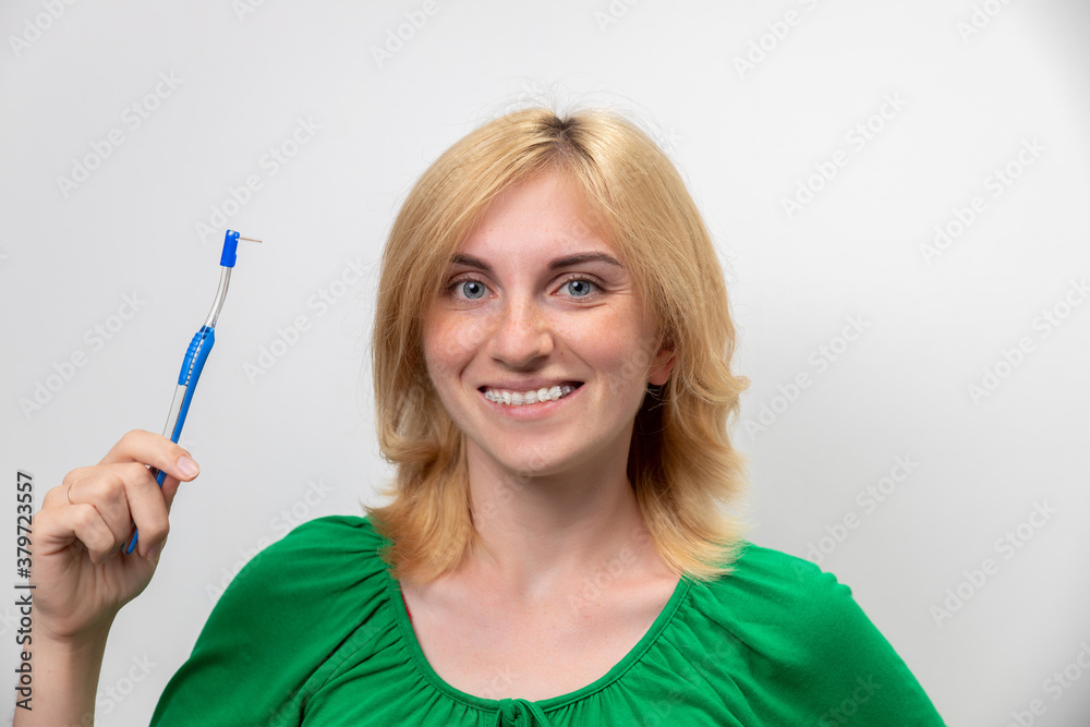 Portrait of a beautiful woman with braces on her teeth, isolated on a white background. The concept of the perfect smile Portrait of a beautiful woman with braces on her teeth, isolated on a white background. The concept of the perfect smile
