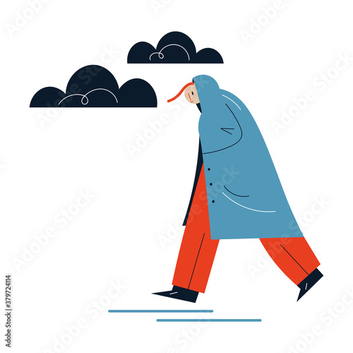 Man in raincoat hurrying up somewhere during rain in autumn