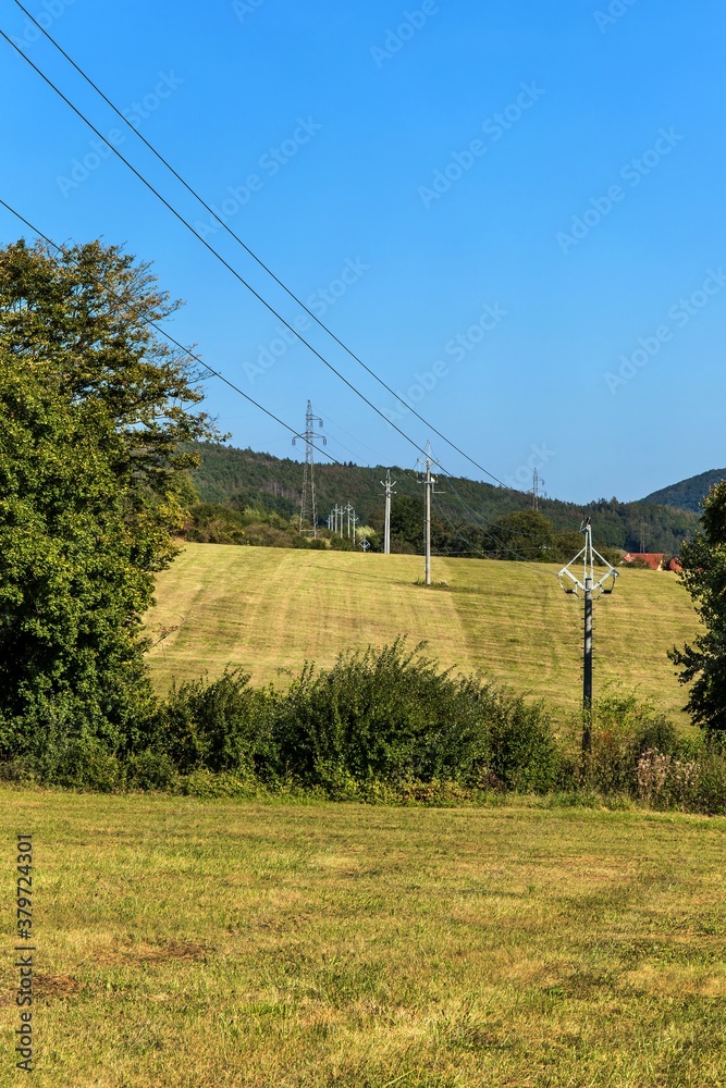 Power poles in the landscape of the Czech Republic. Electricity distribution. Ecological energy. Energy concept.