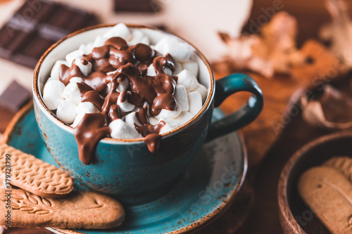 Close-up of hot chocolate with marshmallows on the table. Autumn or winter cozy still life. photo