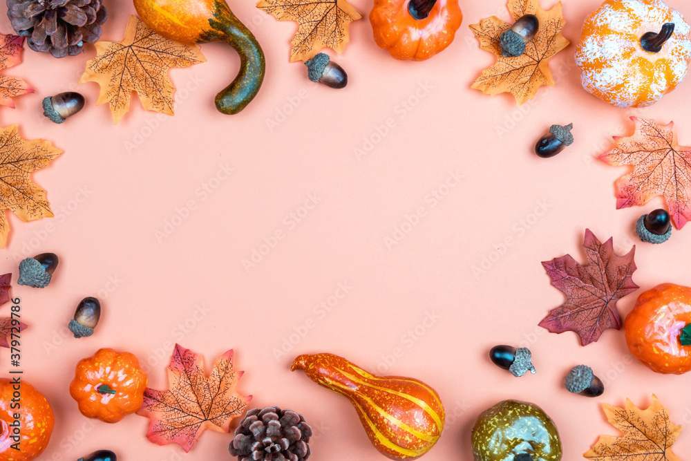 Autumn orange background with pumpkins, leaves and acorns