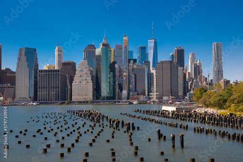 New York city view of lower manhattan financial district from across east river with wood pilings