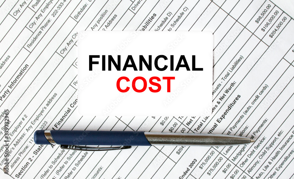Text Financial Cost written on a business card lying on financial tables with a blue metal pen Text Financial Cost written on a business card lying on financial tables with a blue metal pen