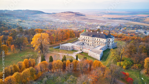 Obraz na płótnie Podgortsy Palace from the air. Sunset over autumn park on hills. Aerial view of Pidhirtsi Castle w salonie