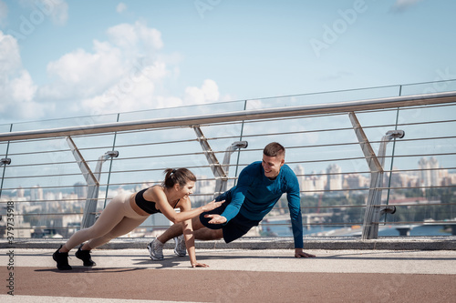 Man and woman making sport training outdoors together