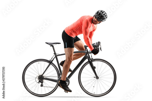 Fototapeta Naklejka Na Ścianę i Meble - Cyclist with helmet and sunglasses riding a road bicycle and looking backwards