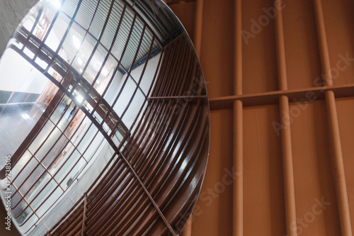 Round panoramic mirror in jail. Controlled access.