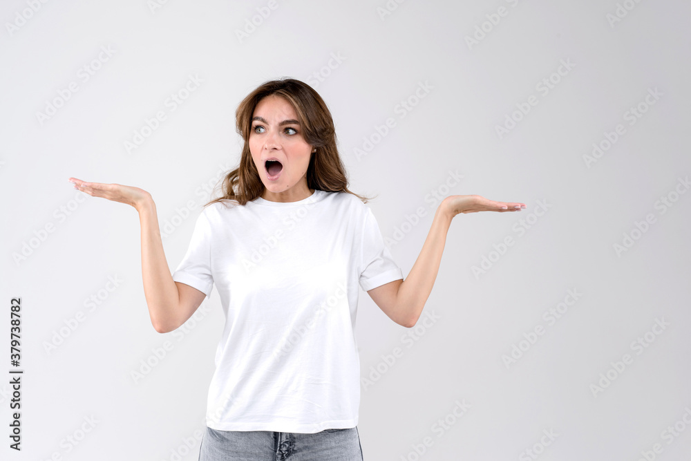 Closeup portrait of a wondering and shoked woman, in full disbelief hands in air, isolated on white background Closeup portrait of a wondering and shoked woman, in full disbelief hands in air, isolated on white background