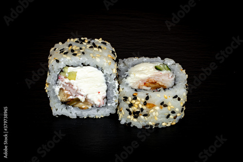 Sushi and rolls on a black