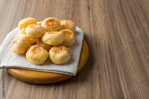 Traditional Brazilian Snack Cheese Bread. On a wooden table background. with copy space