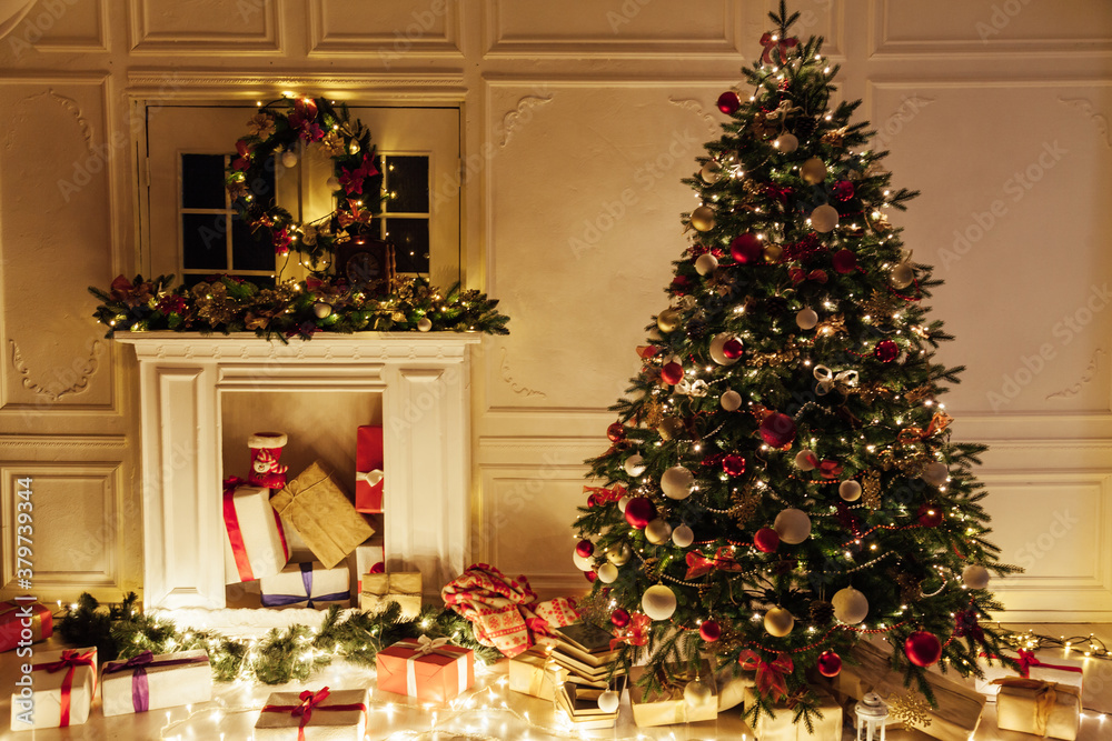 Christmas tree with gifts of garland lights for the new year in the interior of the night room as a backdrop