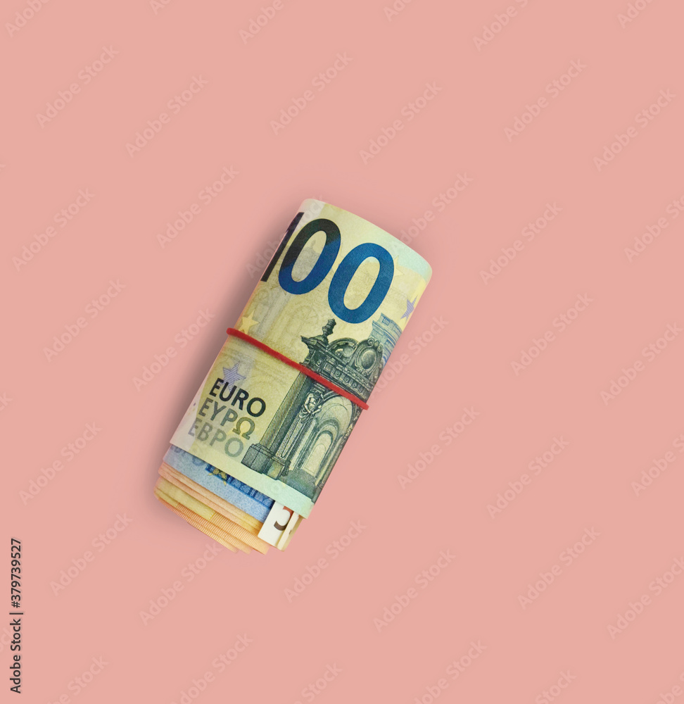Roll of 100 euro banknotes with red rubber band on pink background. Roll of  money. Stock Photo | Adobe Stock