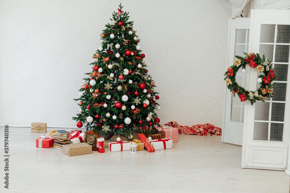 Christmas tree with gifts of garland lights for the new year in the interior of the room as a white background