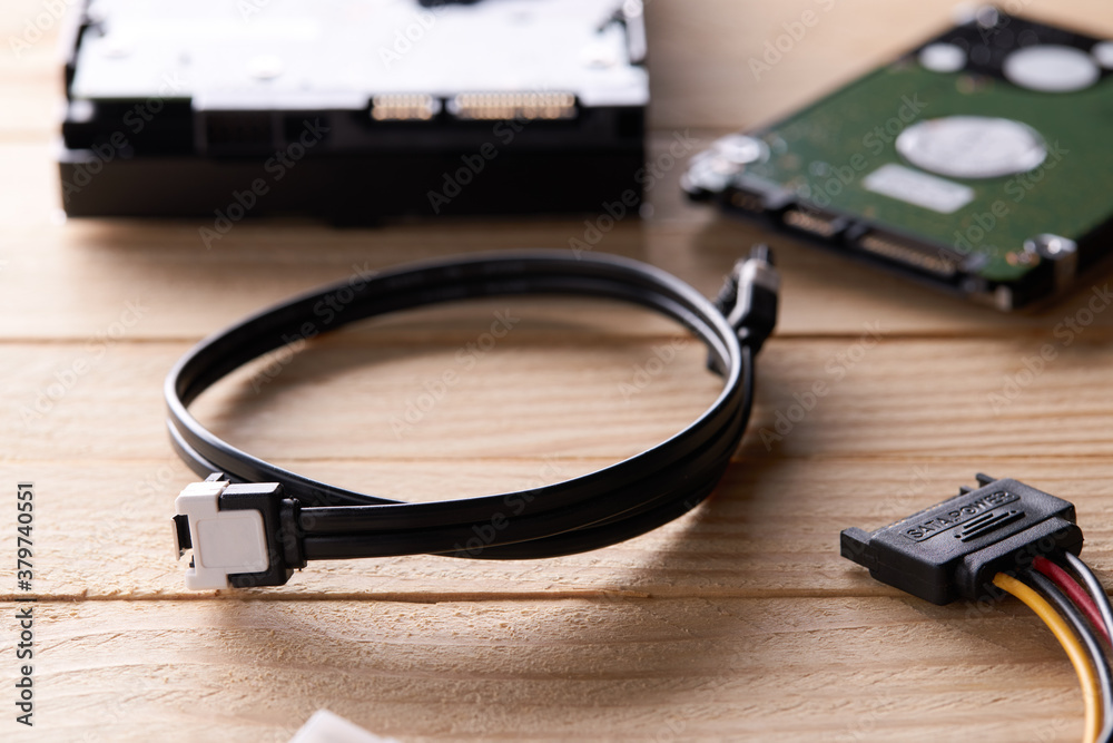 data storage hardware for desktop and laptop computers. backup data technology concept. stack of hard drive disc over wooden background. information recovery conceptual data storage hardware for desktop and laptop computers. backup data technology concept. stack of hard drive disc over wooden background. information recovery conceptual