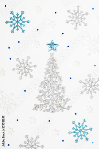 Christmas or New Year s composition 2021. Beautiful xmas tree made of blue and silver decorations on a white background. Greeting card mockup. Flat lay