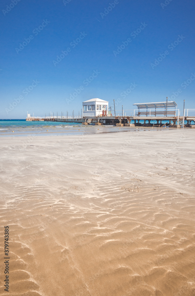 beautiful beach with lifeguard hut on sunny day/Empty sandy beach. Deserted beautiful beach with lifeguard hut beautiful beach with lifeguard hut on sunny day/Empty sandy beach. Deserted beautiful beach with lifeguard hut