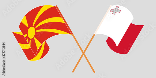 Crossed and waving flags of North Macedonia and Malta