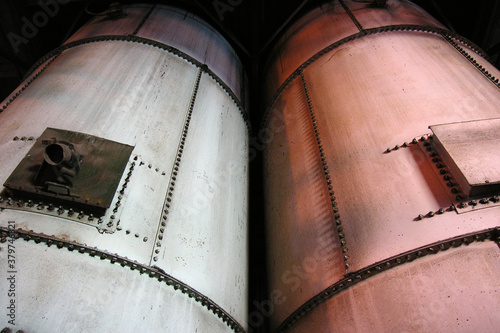 View of industrial tanks at old, closed electric power plant in Southern California.