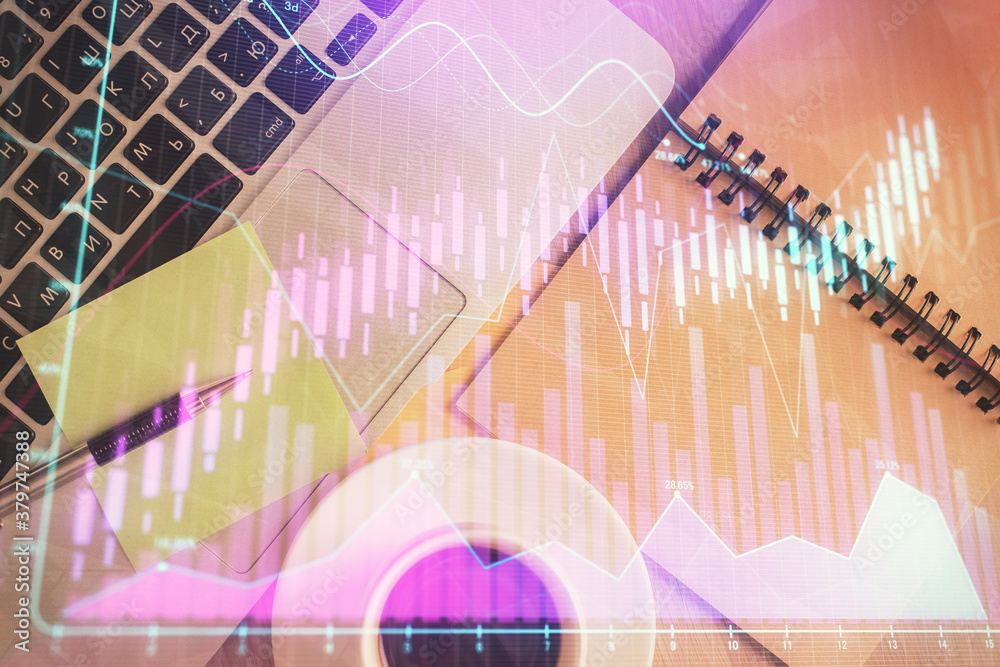 Stock market graph and top view computer on the table background. Double exposure. Concept of financial education. Stock market graph and top view computer on the table background. Double exposure. Concept of financial education.