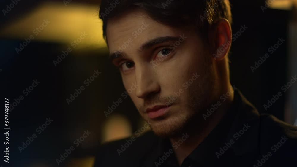 Focused man looking camera indoors. Handsome guy studying someone in front him Focused man looking camera indoors. Handsome guy studying someone in front him