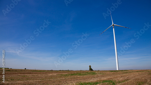 wind power plant over the deep blue sky. Sunny day, Summertime,
