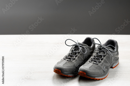 trekking sneakers with red sole, gray copy-space background