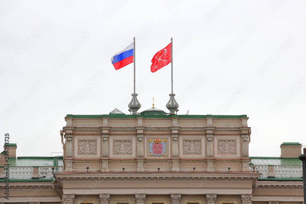 Fototapeta premium The Russia Flag, beside the Flag of Saint Petersburg, Russia