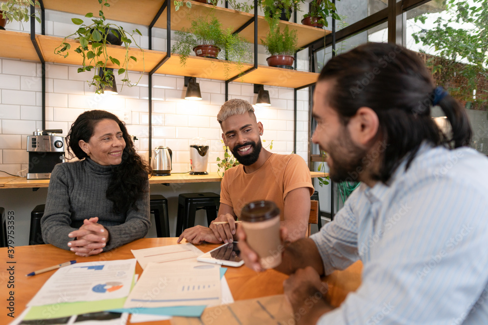 Obraz premium Happy brazilian group of entrepreneurs with big smile discussing sales strategy and planning in office workspace Communication, workspace, meeting concept..