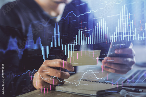 Schilderij op canvas Double exposure of man's hands holding and using a phone and financial graph drawing