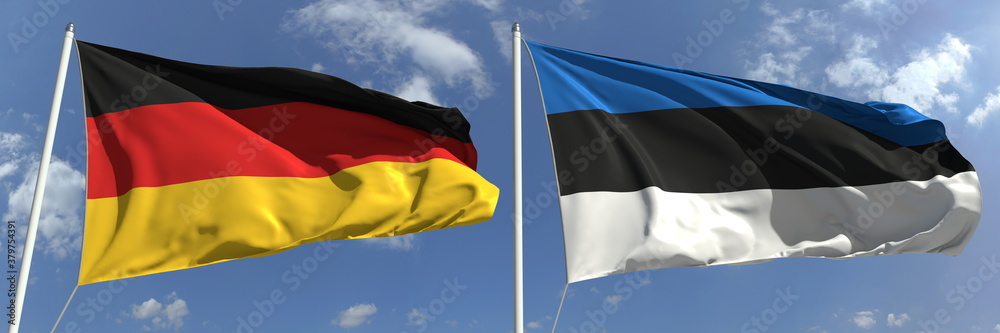 Naklejka premium Flying flags of Germany and Estonia on sky background, 3d rendering