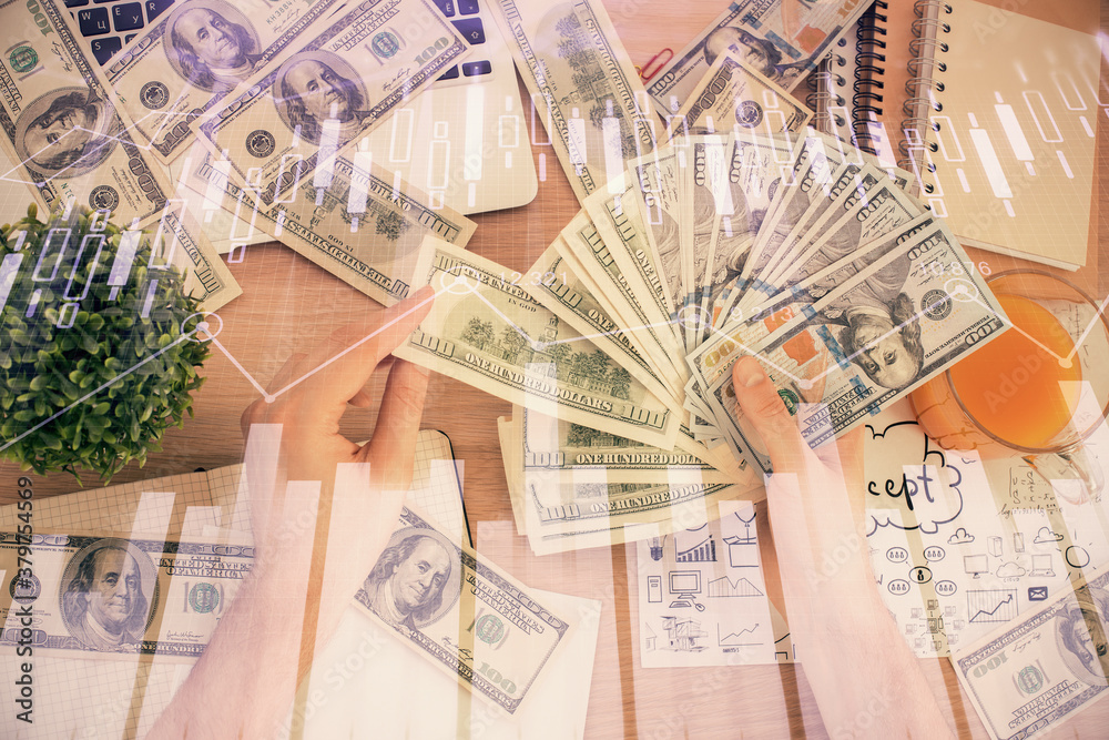Multi exposure of financial graph drawing hologram and USA dollars bills and man hands. Analysis concept. Multi exposure of financial graph drawing hologram and USA dollars bills and man hands. Analysis concept.