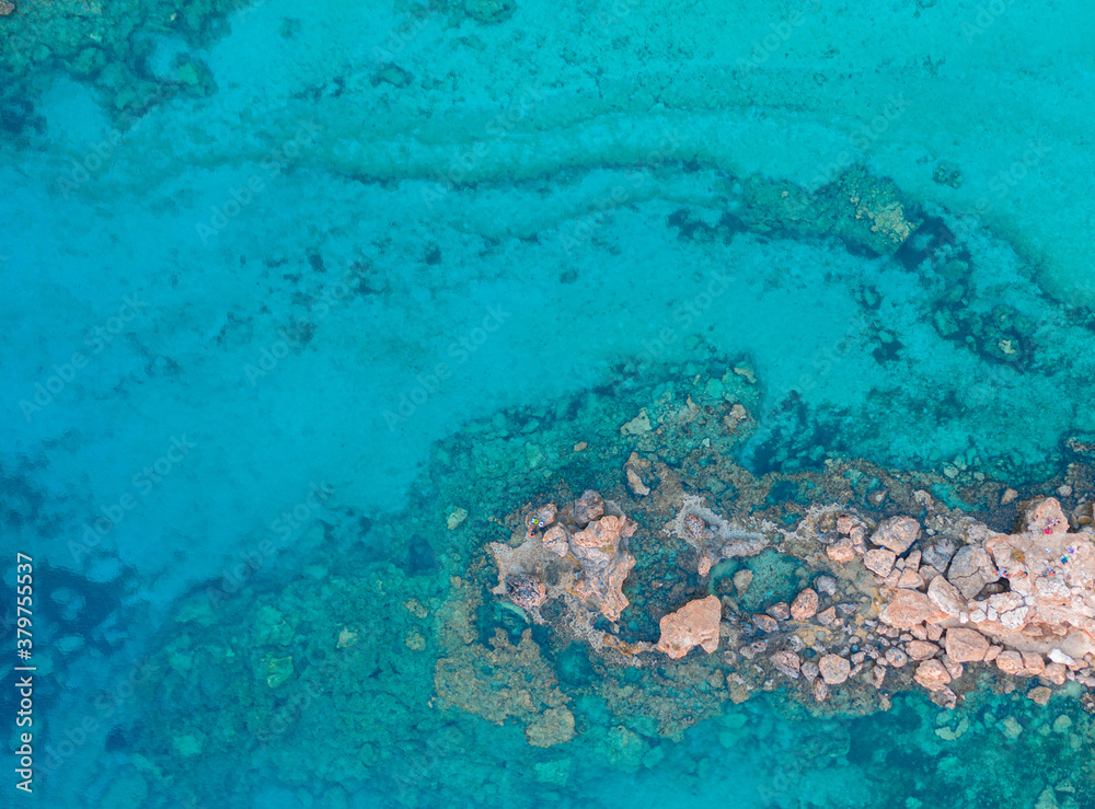An aerial view of the beautiful Mediterranean Sea, where you can see the cracked rocky textured underwater corals and the clean turquoise water of Protaras, Cyprus, An aerial view of the beautiful Mediterranean Sea, where you can see the cracked rocky textured underwater corals and the clean turquoise water of Protaras, Cyprus,