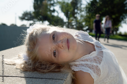 beautiful little girl in a white dress as a portrait