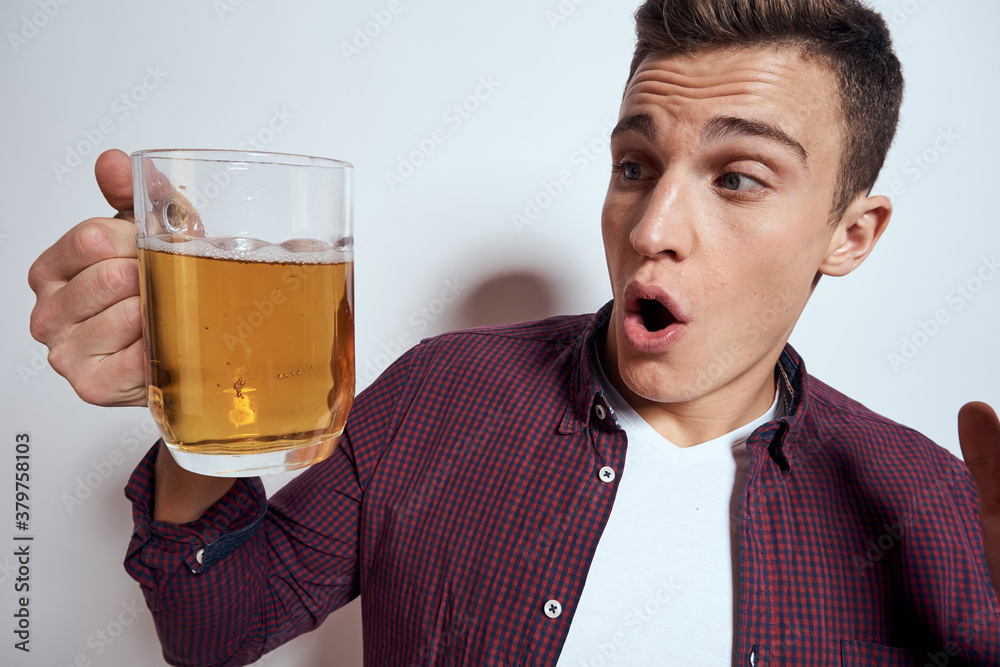 Cheerful man with mug of beer alcohol emotions light background Cheerful man with mug of beer alcohol emotions light background