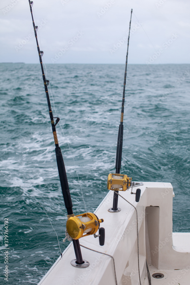 Two fishing rods on a fishing boat charter in Varadero, Cuba for a day  excursion deep-sea fishingon the Caribbean Ocean Stock Photo
