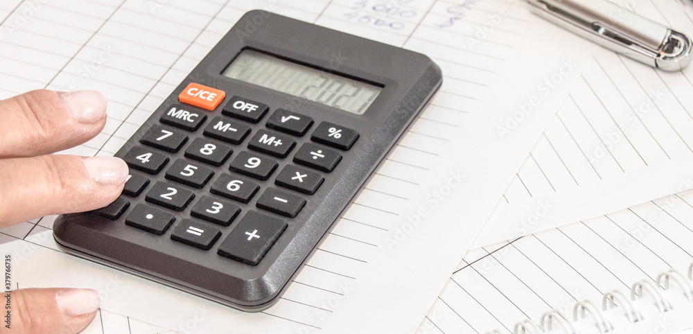Market analysis and financial reporting using a calculator, business concept Market analysis and financial reporting using a calculator, business concept