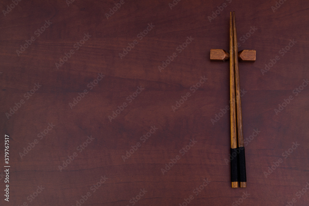 Wooden chopsticks on wooden table with copy space