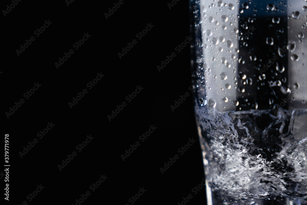 Spin water in glass, Abstract black background, water splash with bubbles. Spin water in glass, Abstract black background, water splash with bubbles.