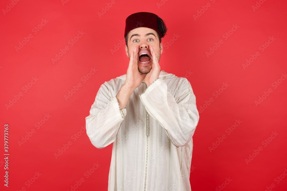 Young caucasian businessman wearing red shirt over yellow background, shouting excited to front. Young caucasian businessman wearing red shirt over yellow background, shouting excited to front.
