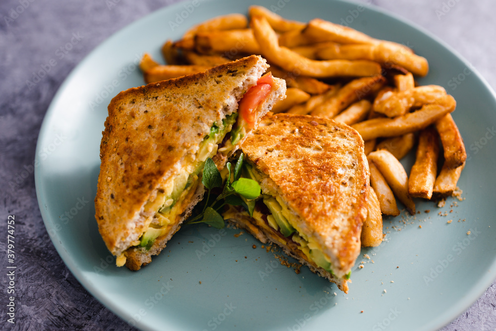 plant-based food,  vegan avocado tomato and dairy-free cheese sandwiches with french fries